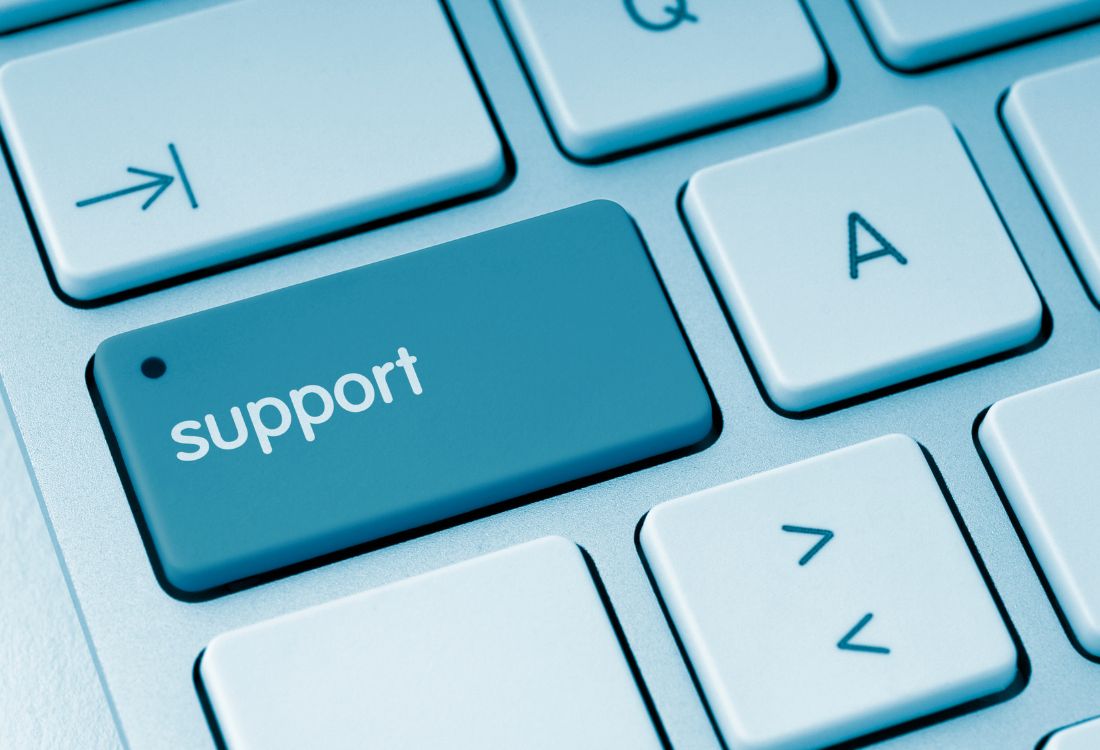 A keyboard with the word support written on it connoting IT support
